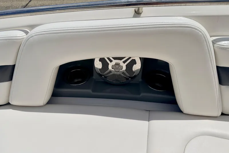 Slide: The Image of 2015 Chaparral Sunesta 264 boat interior with white seating and speaker system. - 80