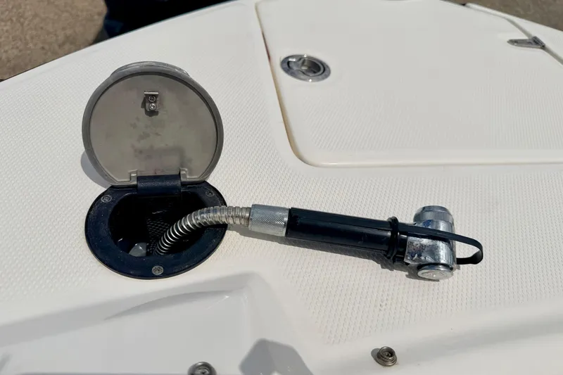 Slide: The Image of 2015 Chaparral Sunesta 264 boat deck with open hatch and hose attachment. - 82