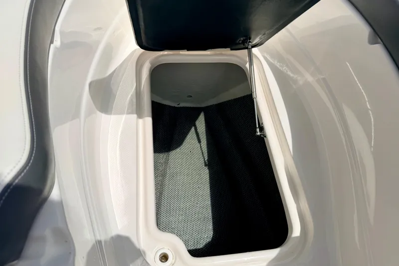 Slide: The Image of Open storage compartment in 2015 Chaparral Sunesta 264 boat, featuring sleek white interior design. - 86