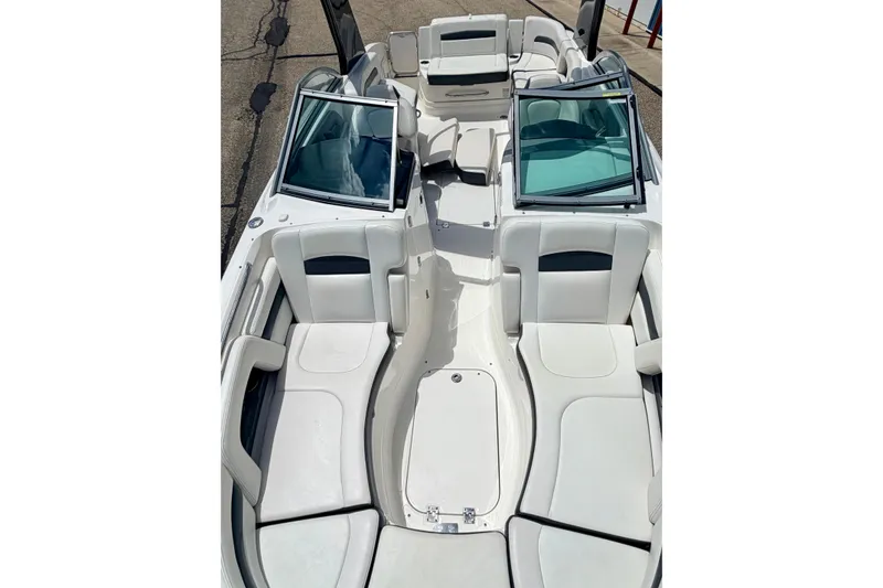 Slide: The Image of 2015 Chaparral Sunesta 264 boat interior with white seating and open windshield. - 87