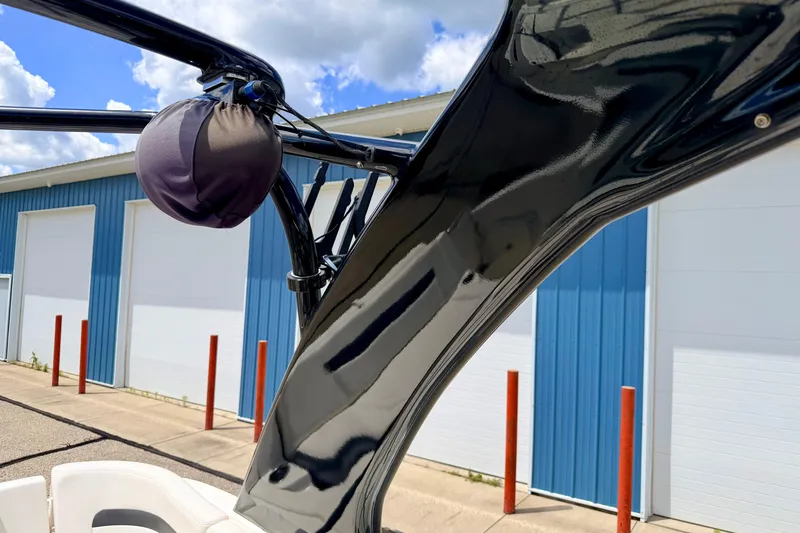 Slide: The Image of 2015 Chaparral Sunesta 264 boat detail with blue storage building background. - 92