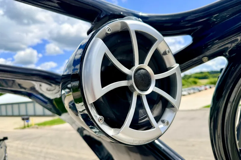 Slide: The Image of Close-up of a speaker on a 2015 Chaparral Sunesta 264 boat, with a clear sky background. - 94
