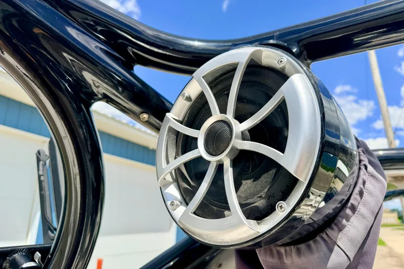 Slide: The Image of Close-up of a speaker on a 2015 Chaparral Sunesta 264 boat under a clear blue sky. - 97
