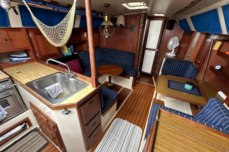 Slide: The Image of Interior of a 1985 Catalina 36 sailboat with wood finishes and cozy seating. - 16