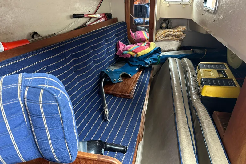 Slide: The Image of Interior of 1985 Catalina 36 sailboat with striped seating and nautical equipment. - 21