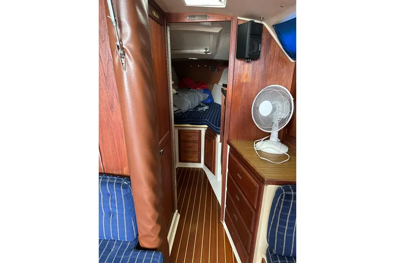 Slide: The Image of Interior of a 1985 Catalina 36 sailboat with wood paneling and a fan. - 22