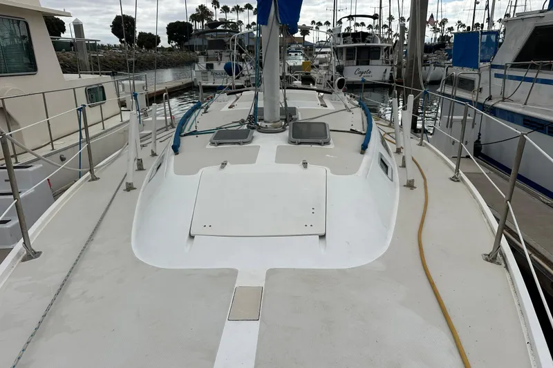 Slide: The Image of 1985 Catalina 36 sailboat docked at marina, view of deck and mast. - 28