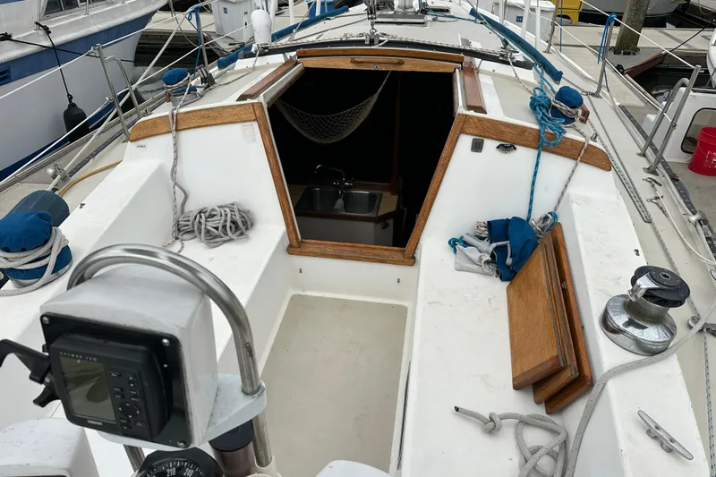 Slide: The Image of 1985 Catalina 36 sailboat cockpit with ropes, winch, and open cabin entrance. - 29