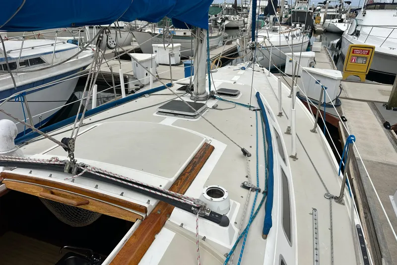 Slide: The Image of Sailboat docked at marina, Catalina 36 model from 1985, with visible rigging and deck details. - 30