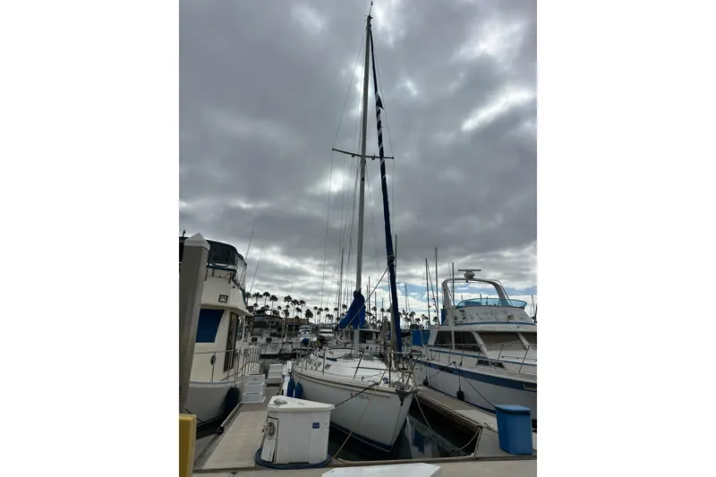 Slide: The Image of Sailboat docked at marina under cloudy sky, Catalina 36, 1985 model. - 34