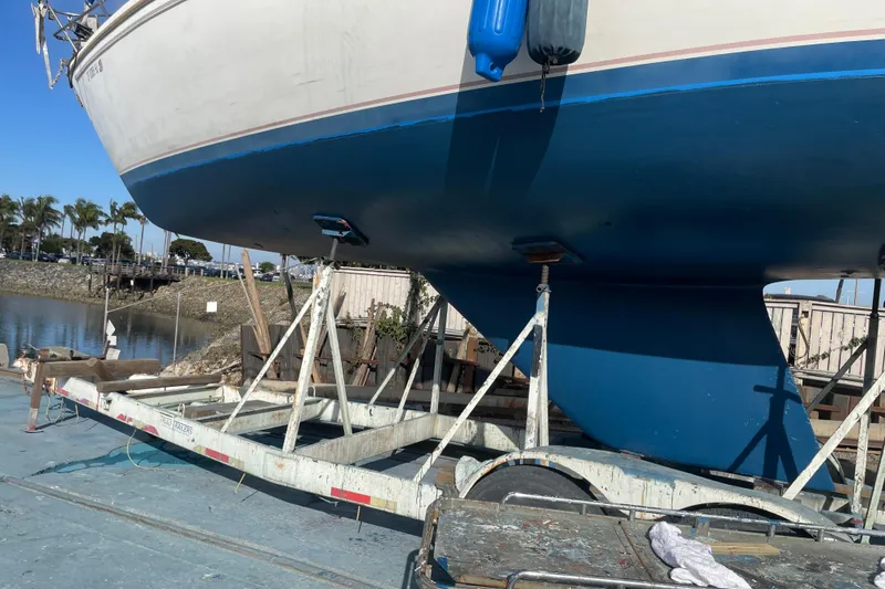 Slide: The Image of Catalina 36 sailboat from 1985 on trailer, blue hull, dockside setting. - 36