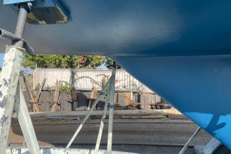 Slide: The Image of Catalina 36 sailboat hull from 1985 on stands, outdoor setting. - 38