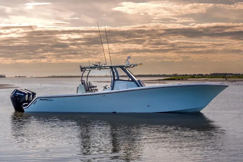 The Image of 2024 Front Runner 36 Center Console boat on calm water at sunset. - 1