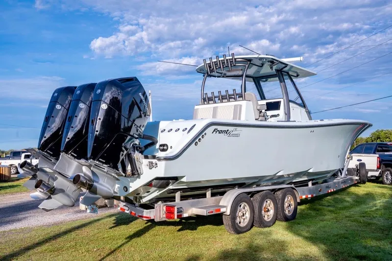 Slide: The Image of 2024 Front Runner 36 Center Console boat on trailer with triple outboard engines. - 12