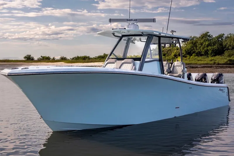 Slide: The Image of 2024 Front Runner 36 Center Console boat on calm water, featuring sleek design and modern equipment. - 2