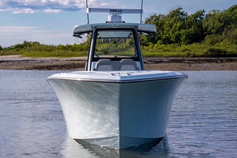 Slide: The Image of 2024 Front Runner 36 Center Console boat on calm water, showcasing sleek design. - 4