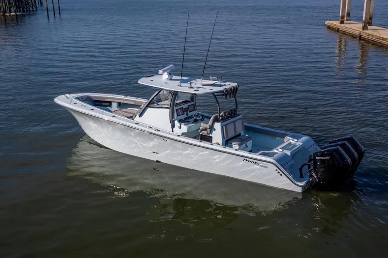 Slide: The Image of 2024 Front Runner 36 Center Console boat on calm water, featuring triple Mercury engines. - 7