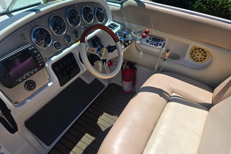 Slide: The Image of Interior of 2002 Chris-Craft Launch 28 GT I/O boat with steering wheel and dashboard controls. - 14