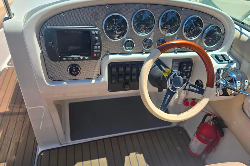 Slide: The Image of Dashboard of a 2002 Chris-Craft Launch 28 GT I/O with gauges and wooden steering wheel. - 20