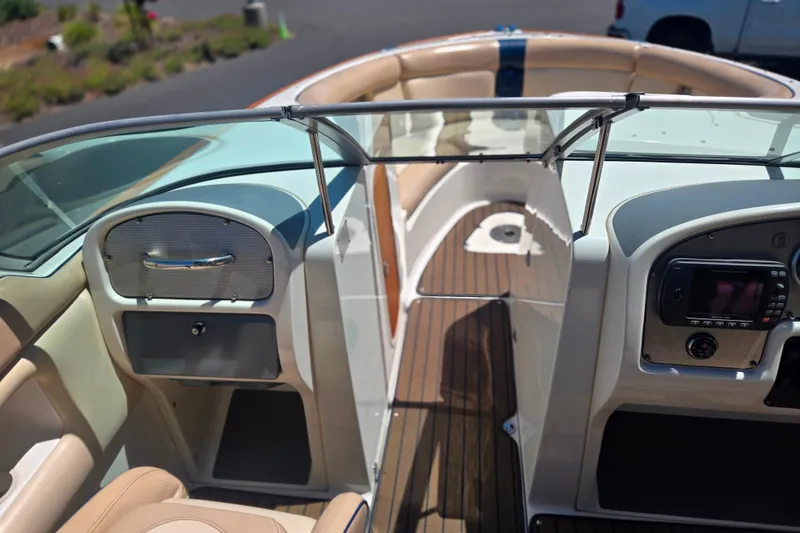 Slide: The Image of Interior view of 2002 Chris-Craft Launch 28 GT I/O boat, featuring elegant seating and dashboard. - 21