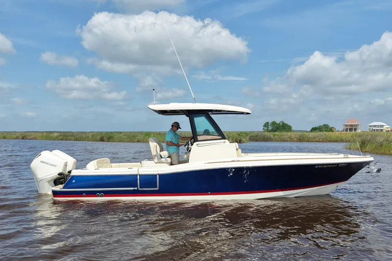 Slide: The Image of 2020 Chris-Craft Catalina 27 boat on water, clear sky background. - 0