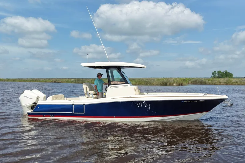 Slide: The Image of 2020 Chris-Craft Catalina 27 boat on water, clear sky background. - 1