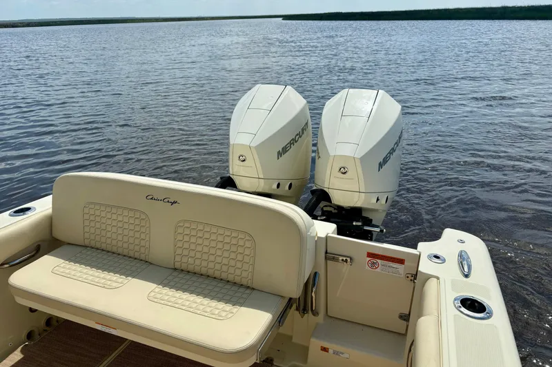 Slide: The Image of 2020 Chris-Craft Catalina 27 boat with dual Mercury engines on a calm lake. - 10