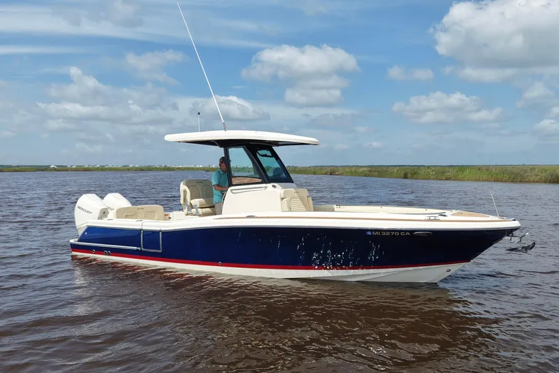Slide: The Image of 2020 Chris-Craft Catalina 27 boat on water, featuring sleek design and modern amenities. - 2