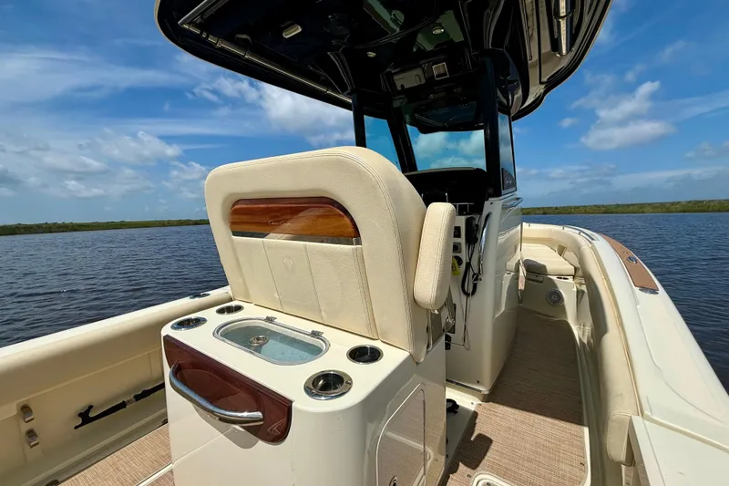 Slide: The Image of 2020 Chris-Craft Catalina 27 boat interior with seating and console, on a sunny day. - 21
