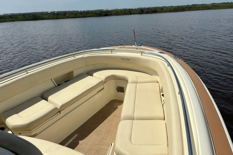 Slide: The Image of 2020 Chris-Craft Catalina 27 boat with beige seating, on calm water. - 27