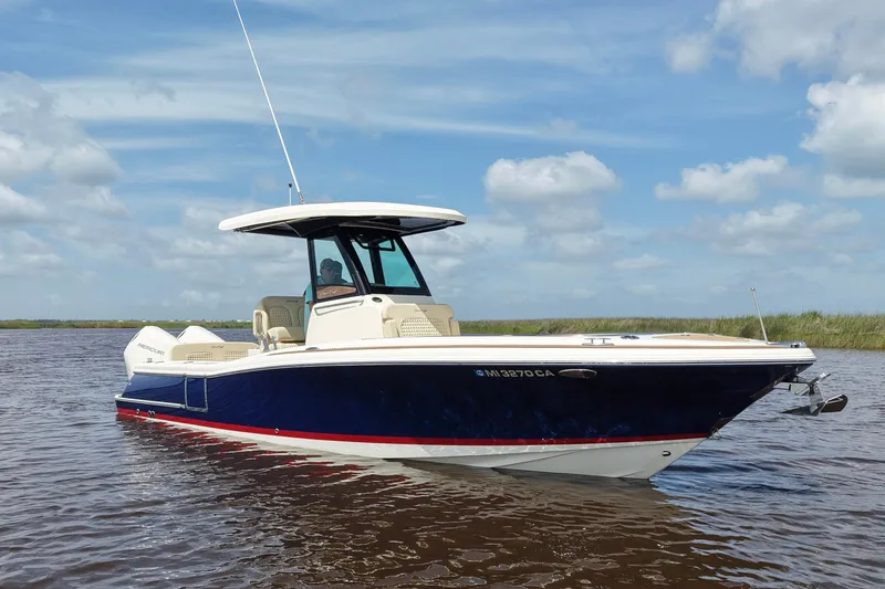 Slide: The Image of 2020 Chris-Craft Catalina 27 boat on calm water under a blue sky. - 3
