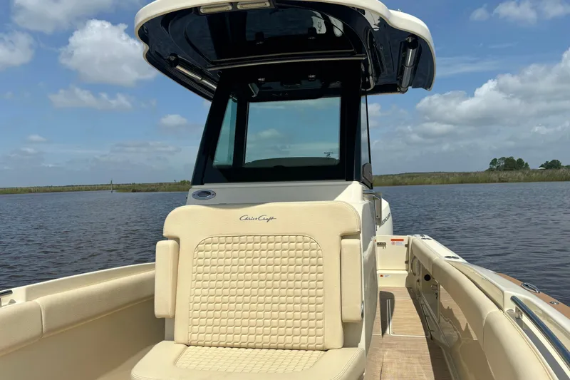 Slide: The Image of 2020 Chris-Craft Catalina 27 boat on calm water under a clear sky. - 32