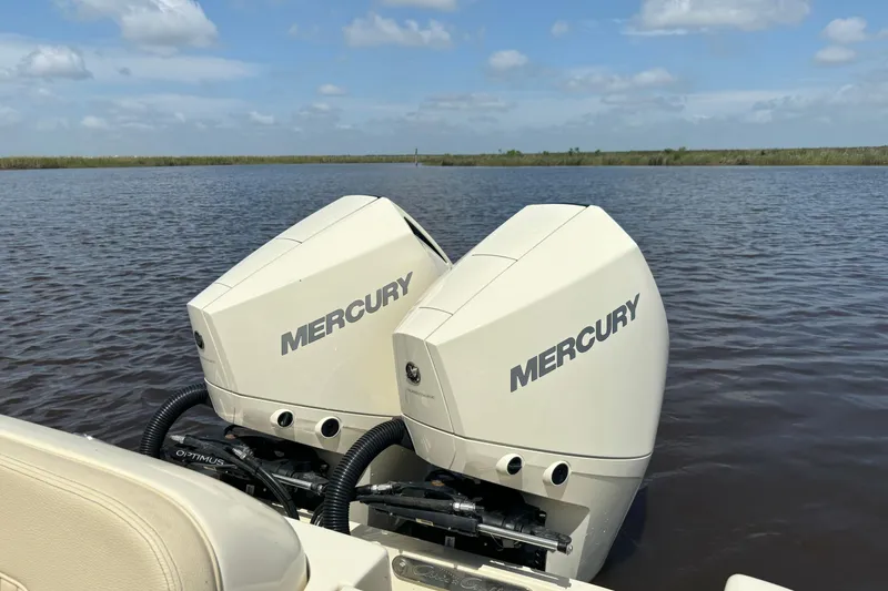 Slide: The Image of Twin Mercury outboard engines on a 2020 Chris-Craft Catalina 27, cruising on a calm lake. - 33