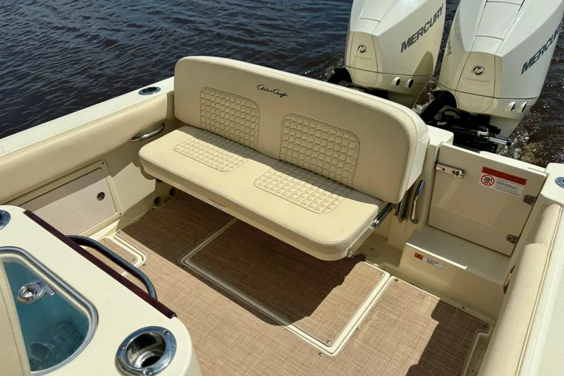 Slide: The Image of 2020 Chris-Craft Catalina 27 boat interior with beige seating and twin Mercury engines. - 36