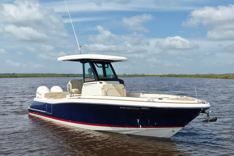 Slide: The Image of 2020 Chris-Craft Catalina 27 boat on calm water under a blue sky. - 4