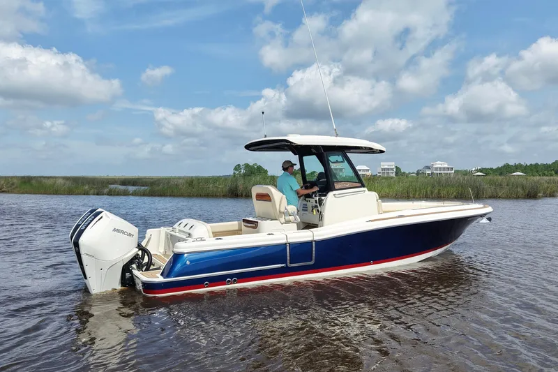 Slide: The Image of 2020 Chris-Craft Catalina 27 boat on water, featuring a sleek design and Mercury engine. - 6