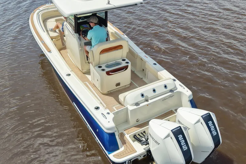 Slide: The Image of 2020 Chris-Craft Catalina 27 boat on water, featuring dual Mercury engines. - 8