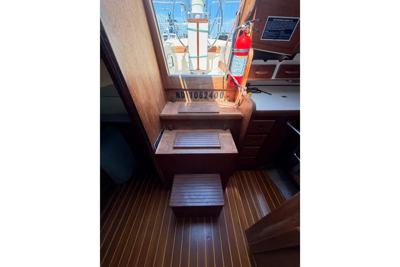 Slide: The Image of Interior of 1991 Caliber 33 sailboat with wooden steps and fire extinguisher. - 48