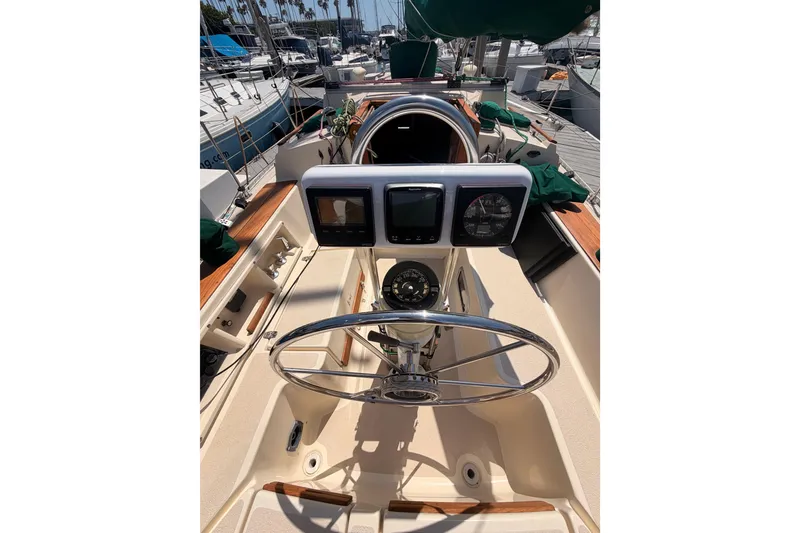 Slide: The Image of Cockpit of 1991 Caliber 33 sailboat with steering wheel and navigation instruments. - 21
