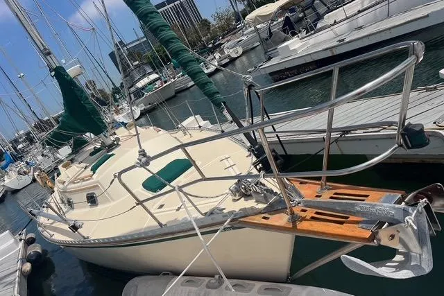 Slide: The Image of Sailboat docked in marina, 1991 Caliber 33 model, with green sail covers. - 10