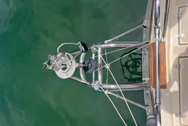 Slide: The Image of Bow of 1991 Caliber 33 sailboat with anchor and rigging over water. - 12