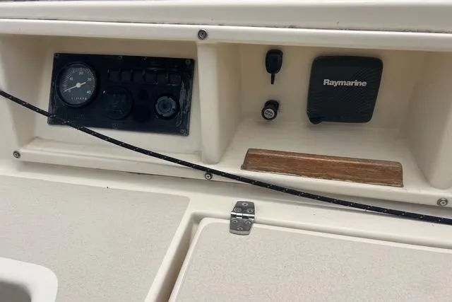 Slide: The Image of Control panel of a 1991 Caliber 33 boat featuring gauges and Raymarine equipment. - 13