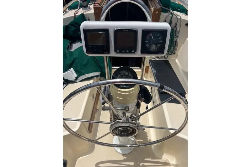 Slide: The Image of Steering wheel and instruments on a 1991 Caliber 33 sailboat cockpit. - 14