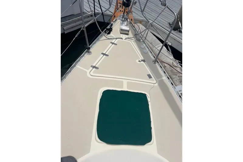 Slide: The Image of 1991 Caliber 33 sailboat deck with green hatch cover and stainless steel railings. - 15