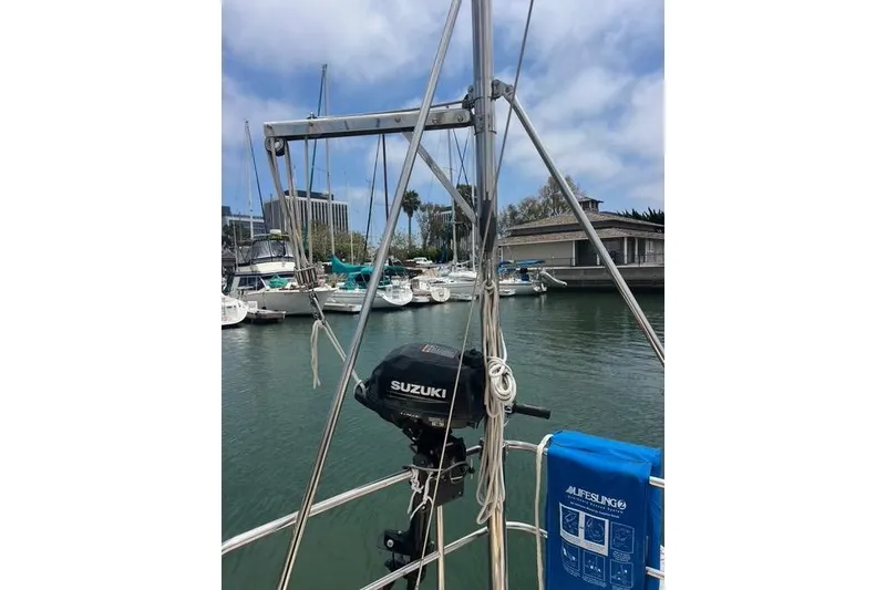 Slide: The Image of Sailboat docked in marina with Suzuki outboard motor, Caliber 33, 1991 model. - 21
