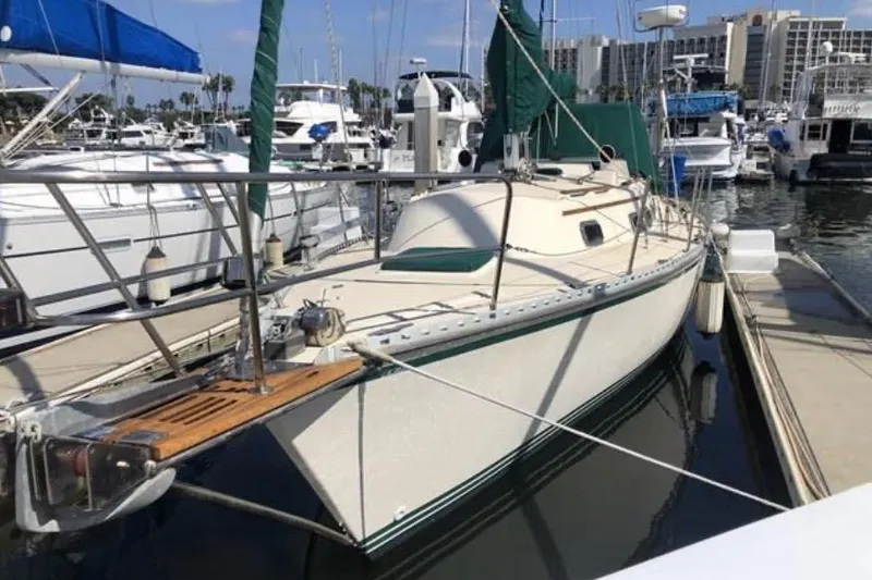 Slide: The Image of Sailboat docked in marina, 1991 Caliber 33 model, surrounded by other boats. - 3