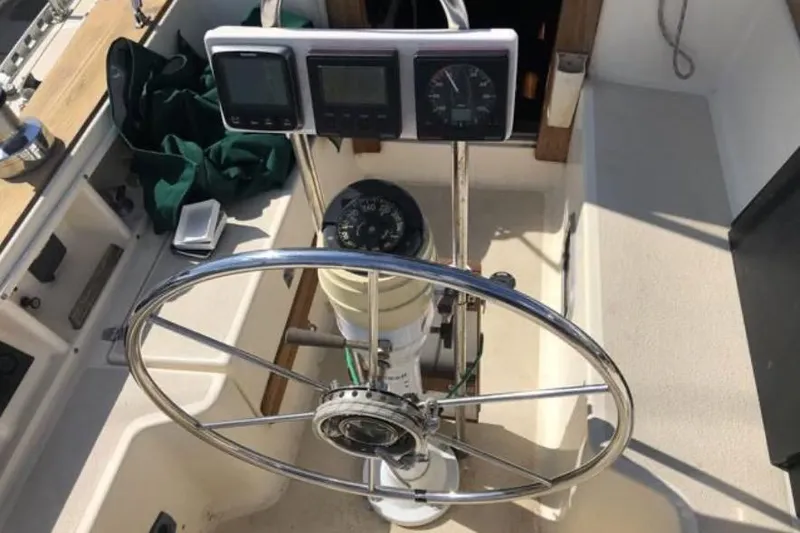 Slide: The Image of Steering wheel and instruments on a 1991 Caliber 33 sailboat cockpit. - 33
