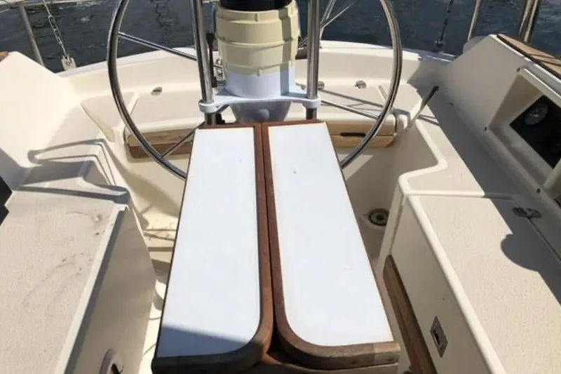 Slide: The Image of Cockpit of 1991 Caliber 33 sailboat with steering wheel and wooden table. - 35