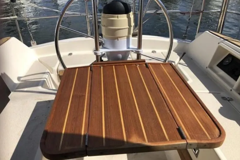Slide: The Image of Cockpit of 1991 Caliber 33 sailboat with wooden table and steering wheel. - 36