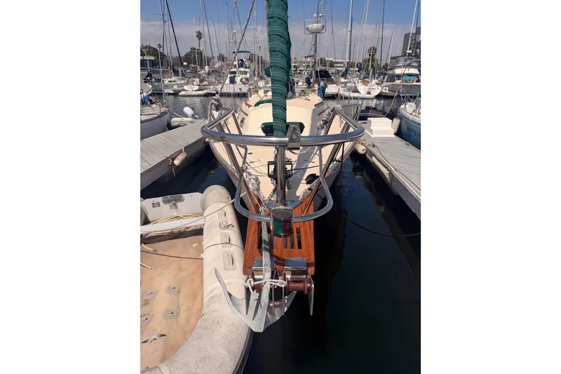 Slide: The Image of 1991 Caliber 33 sailboat docked at marina with inflatable dinghy. - 7